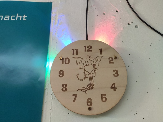 Photo of the clock with a custom clockface lasercut from a piece of plywood